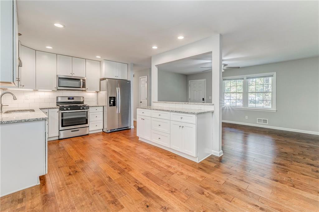 3016 Butler Creek Road Northwest Kennesaw, GA 30152 - Photo 30 of 43 a kitchen with stainless steel appliances a refrigerator sink and stove