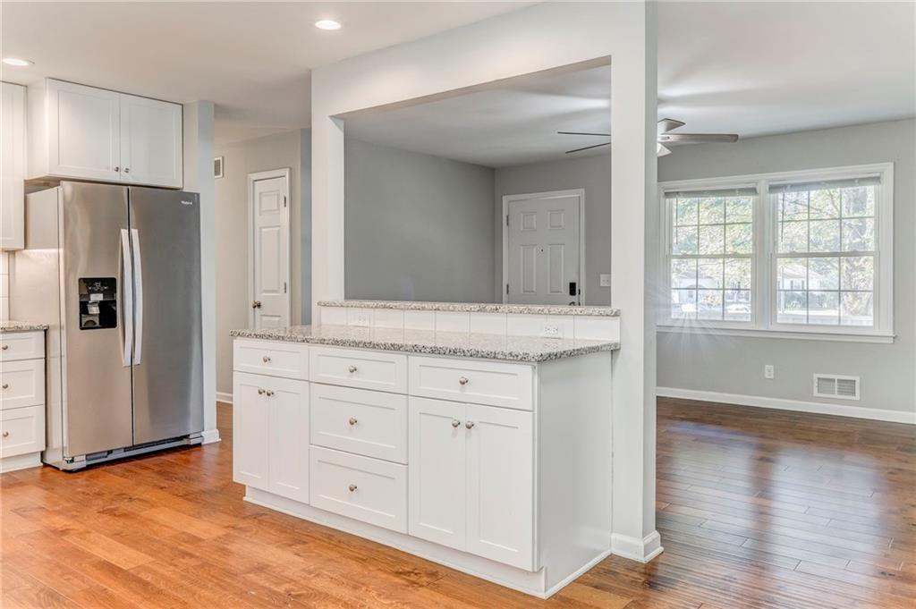 3016 Butler Creek Road Northwest Kennesaw, GA 30152 - Photo 31 of 43 a kitchen with stainless steel appliances granite countertop a refrigerator and a sink