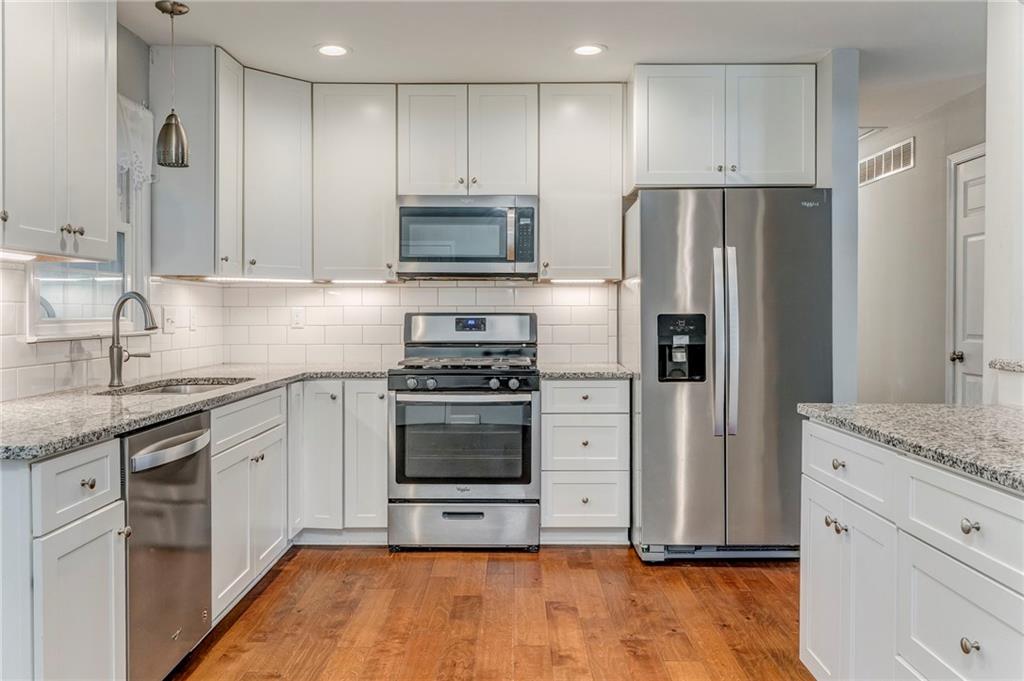 3016 Butler Creek Road Northwest Kennesaw, GA 30152 - Photo 32 of 43 a kitchen with stainless steel appliances granite countertop a refrigerator sink and stove