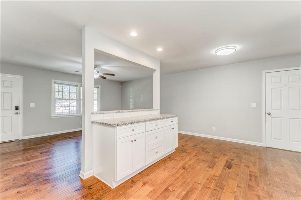 3016 Butler Creek Road Northwest Kennesaw, GA 30152 - Photo 37 of 43 an empty room with wooden floor and cabinet