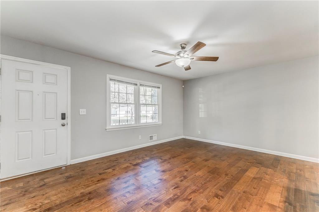 3016 Butler Creek Road Northwest Kennesaw, GA 30152 - Photo 38 of 43 wooden floor in an empty room with a window