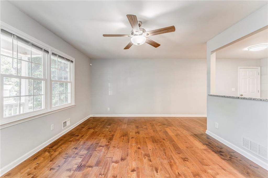 3016 Butler Creek Road Northwest Kennesaw, GA 30152 - Photo 42 of 43 an empty room with wooden floor fan and windows