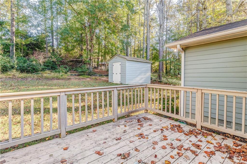3016 Butler Creek Road Northwest Kennesaw, GA 30152 - Photo 6 of 43 a view of a wooden house with a wooden fence