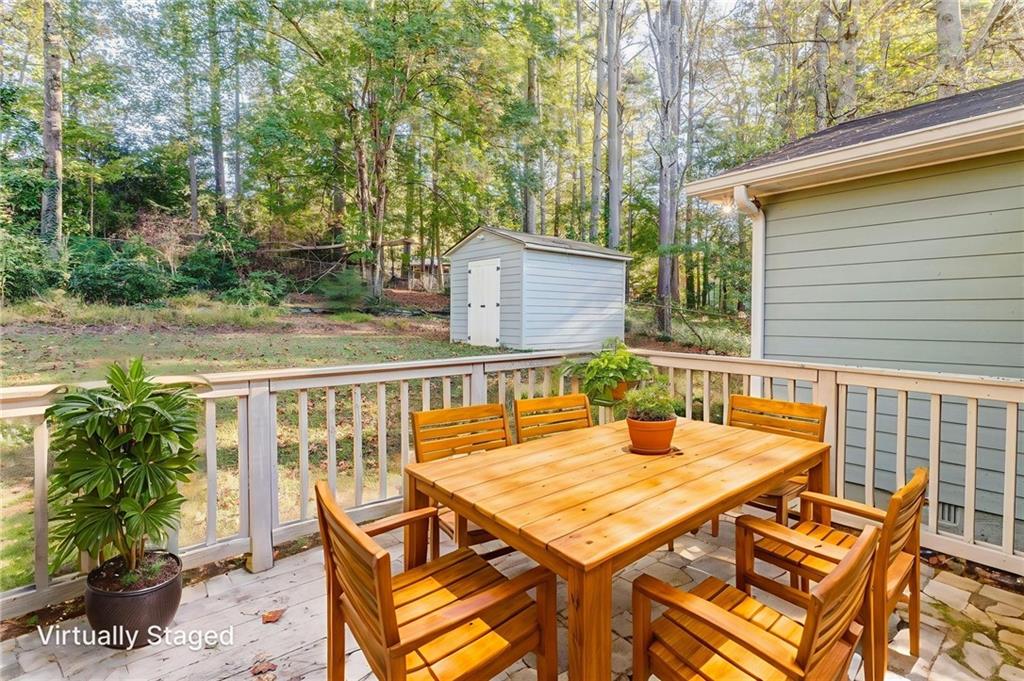 3016 Butler Creek Road Northwest Kennesaw, GA 30152 - Photo 7 of 43 a view of a patio with table and chairs with wooden floor and fence