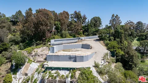 a view of a swimming pool with a yard and plants