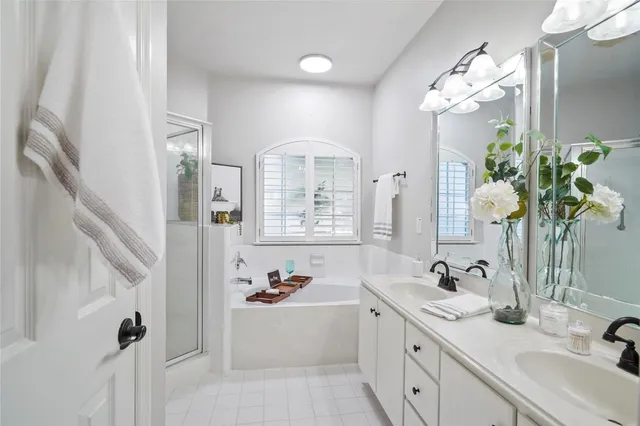 a bathroom with a tub sink and mirror