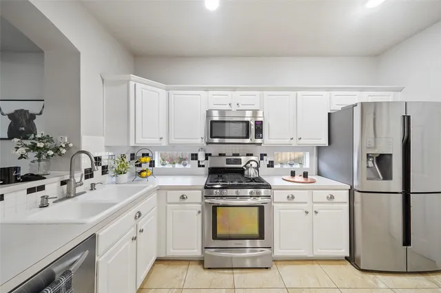 a kitchen with a sink appliances and cabinets