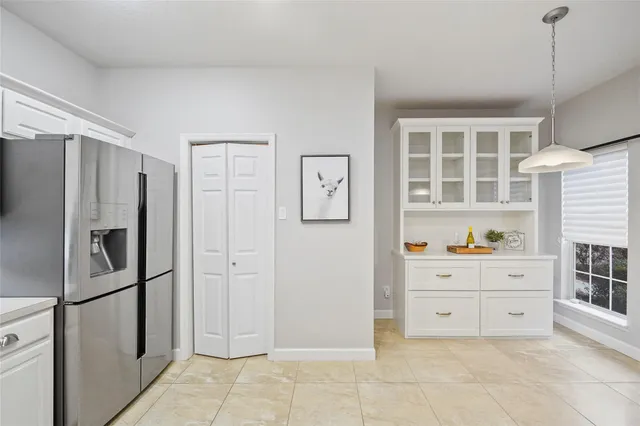 a kitchen with stainless steel appliances a refrigerator and cabinets