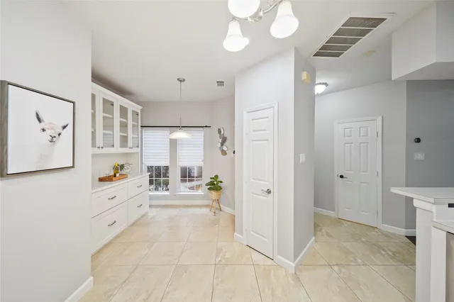 a large white kitchen with a large window
