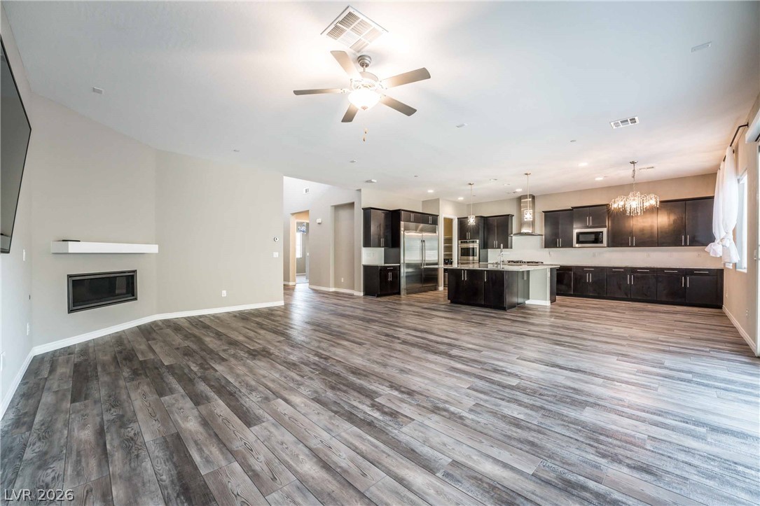 2787 Athens Ridge Drive Henderson, NV 89052 - Photo 5 of 31 An open-concept living space with a modern fireplace and spacious kitchen.