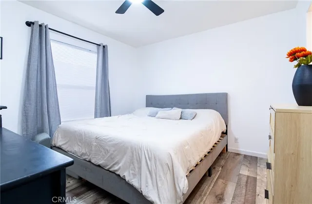 a bedroom with a bed and a desk