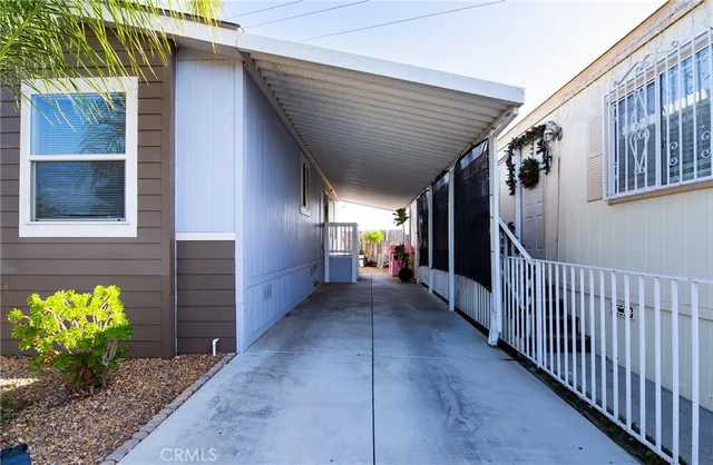 a view of a porch with a table and chairs and potted plants
