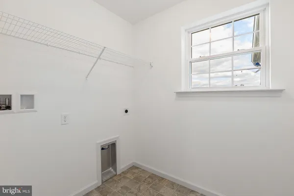 a view of storage and utility room with a window