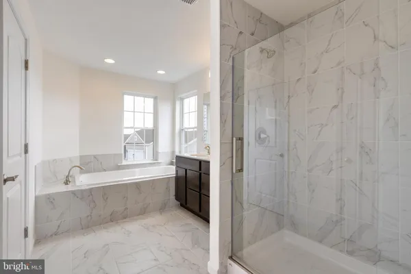 a bathroom with a bathtub and a shower
