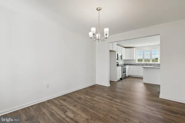 a view of a kitchen with stove and cabinets
