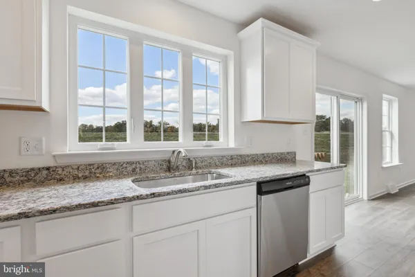 a kitchen with granite countertop a sink and a window