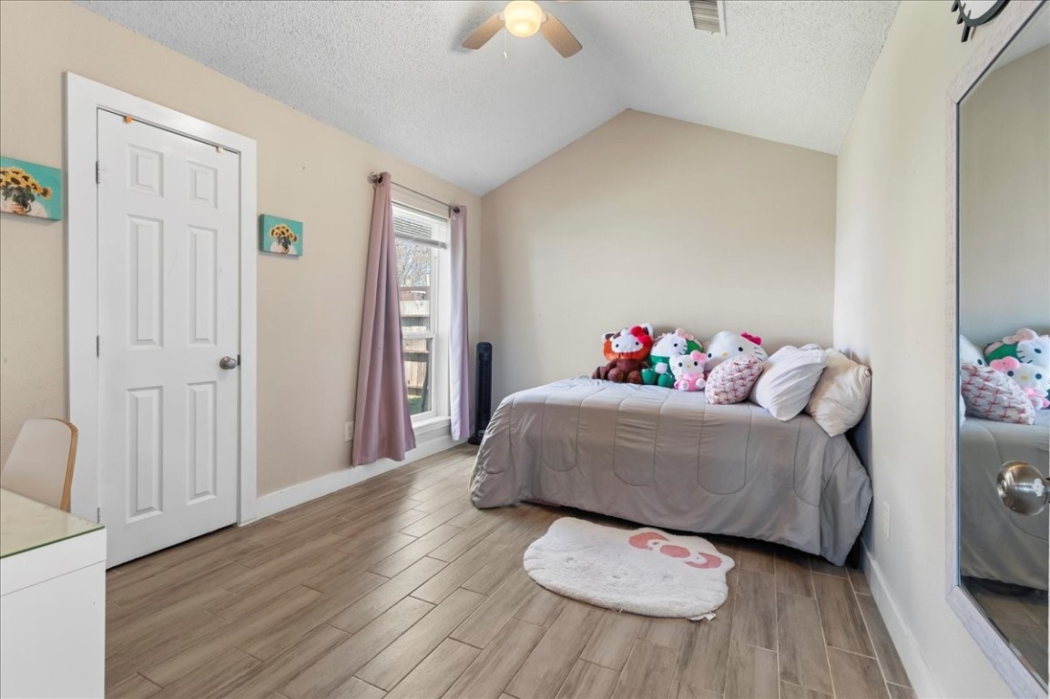 12926 Grovemill Drive Houston, TX 77045 - Photo 13 of 30 a living room with a bed and a chandelier