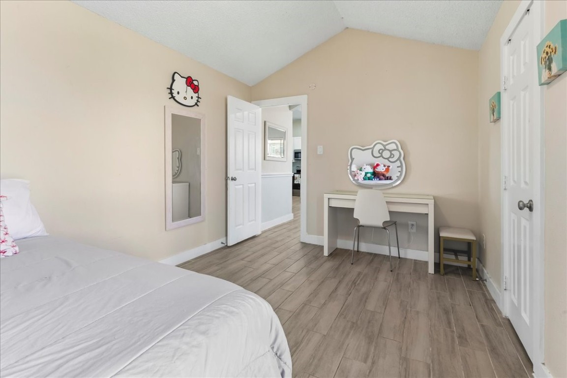 12926 Grovemill Drive Houston, TX 77045 - Photo 14 of 30 a spacious bedroom with a bed and a table in it