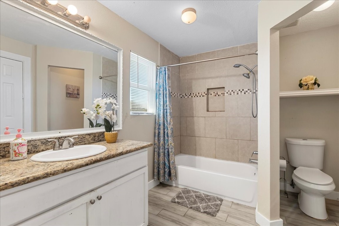 12926 Grovemill Drive Houston, TX 77045 - Photo 16 of 30 a bathroom with a granite countertop sink toilet and shower