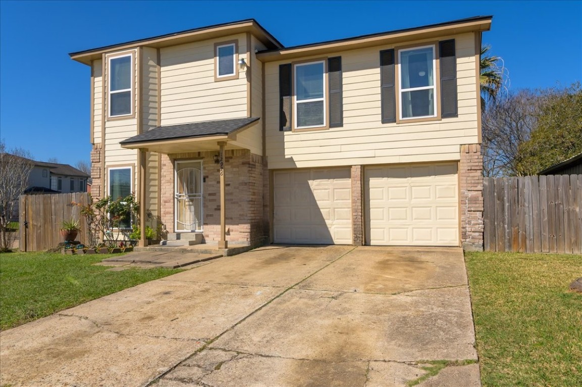 12926 Grovemill Drive Houston, TX 77045 - Photo 2 of 30 a front view of a house with a yard