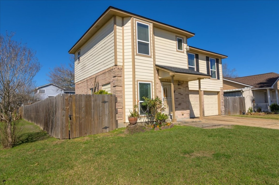 12926 Grovemill Drive Houston, TX 77045 - Photo 24 of 30 a front view of a house with a yard