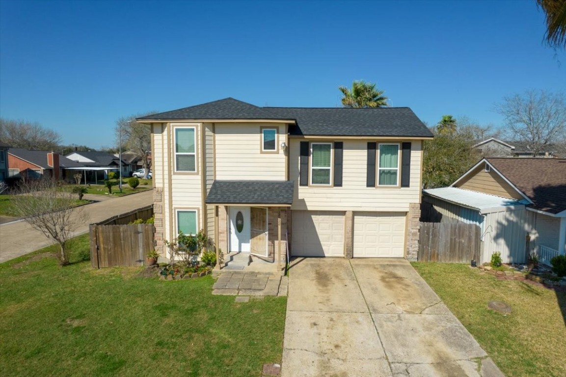 12926 Grovemill Drive Houston, TX 77045 - Photo 26 of 30 a front view of a house with garden