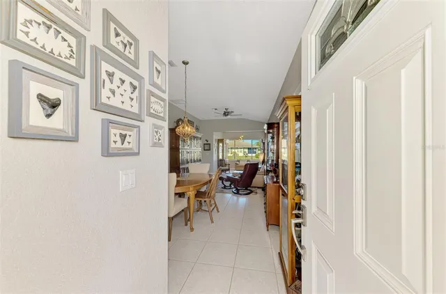 a dining room with furniture a chandelier and window