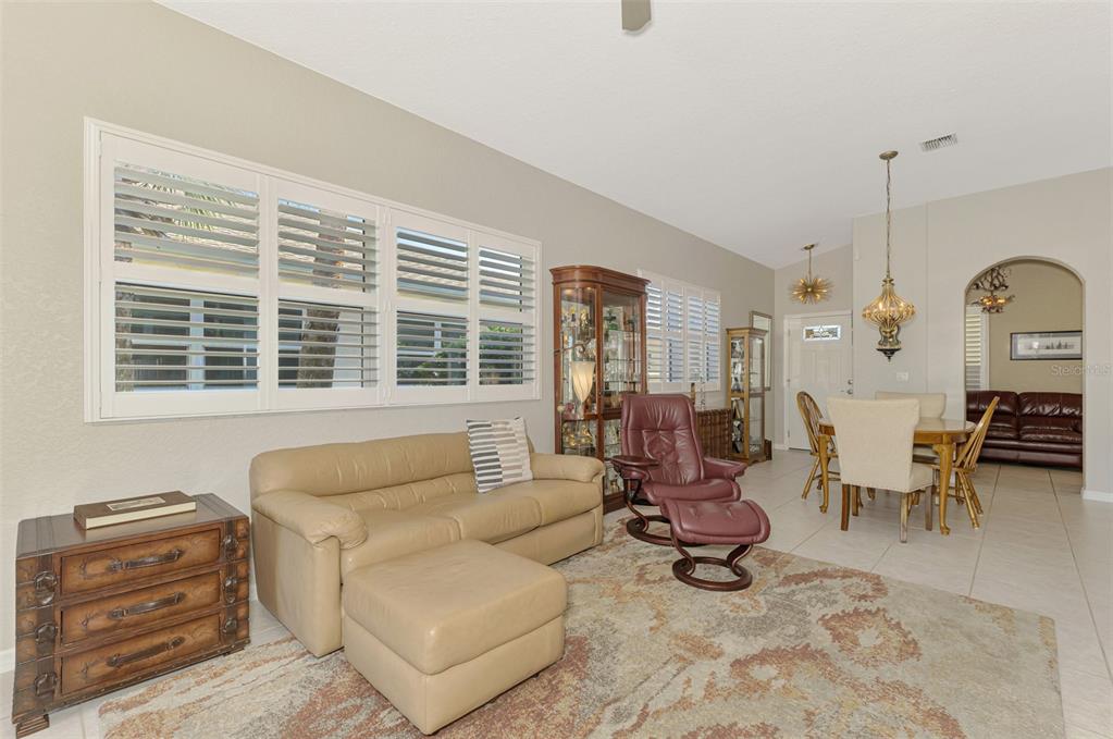 1771 Fountain View Circle Venice, FL 34292 - Photo 20 of 59 a living room with furniture and floor to ceiling windows