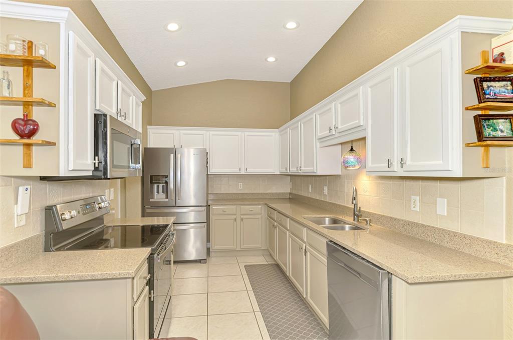 1771 Fountain View Circle Venice, FL 34292 - Photo 26 of 59 a kitchen that has a sink and a stove in it