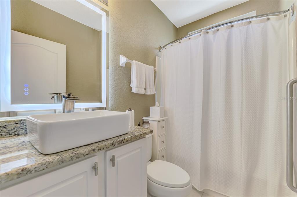 1771 Fountain View Circle Venice, FL 34292 - Photo 39 of 59 a bathroom with a granite countertop sink and a mirror