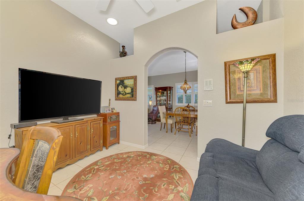 1771 Fountain View Circle Venice, FL 34292 - Photo 41 of 59 a living room with furniture and a flat screen tv