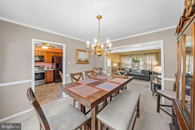 a living room with furniture a chandelier and a table