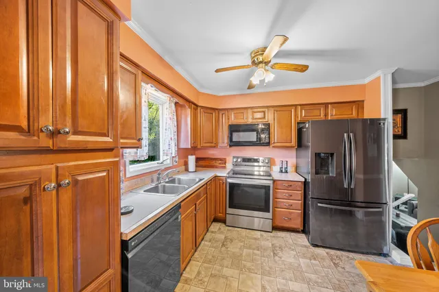 a kitchen with stainless steel appliances granite countertop a refrigerator a sink dishwasher stove with dishwasher and cabinets