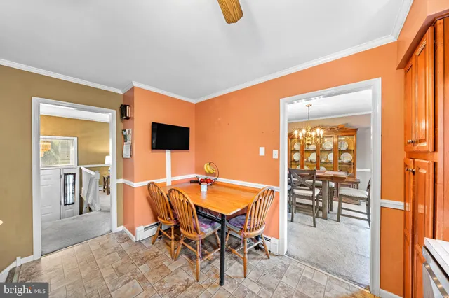 a dining room with furniture and a floor to ceiling window