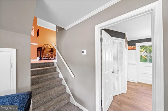 a view of a hallway with wooden floor and entryway