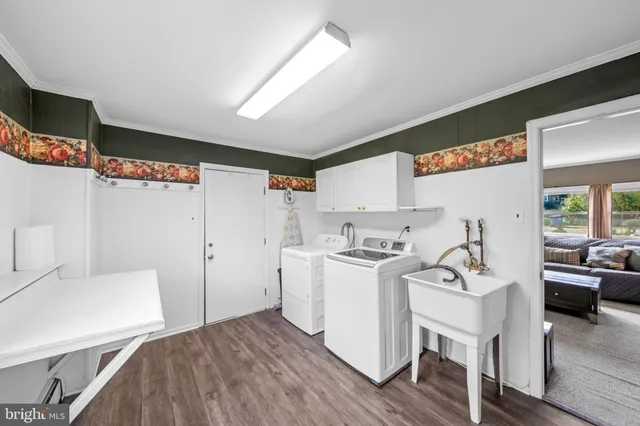 a view of a kitchen with furniture and wooden floor