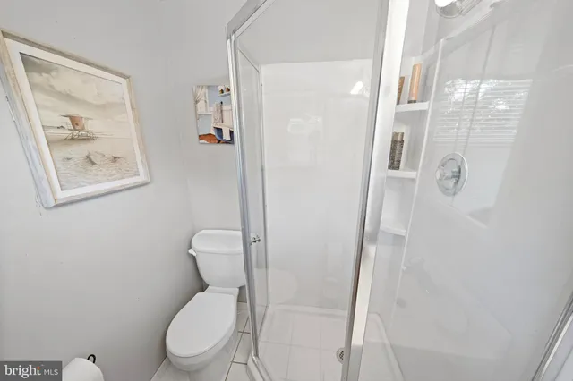 a white toilet sitting next to a bathroom sink