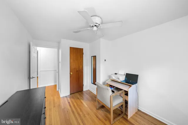 a view of a workspace with furniture and wooden floor
