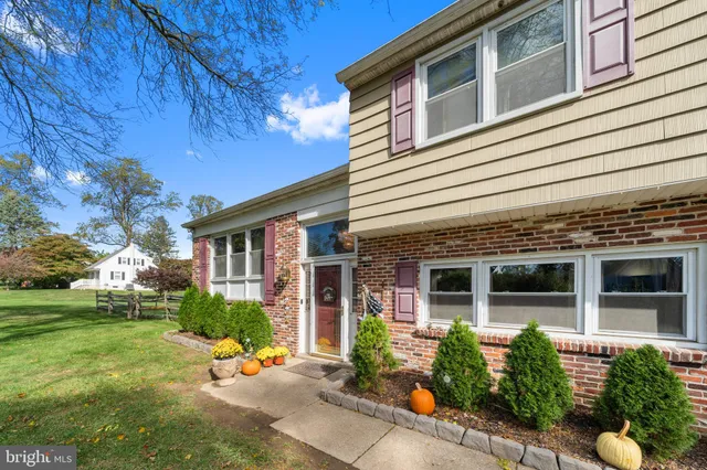 a view of a house with sitting area and garden