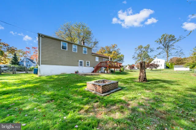 a front view of a house with garden and trees