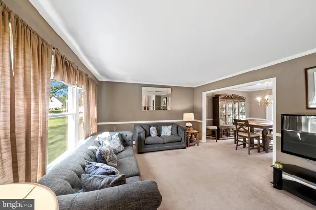 a living room with furniture and large windows