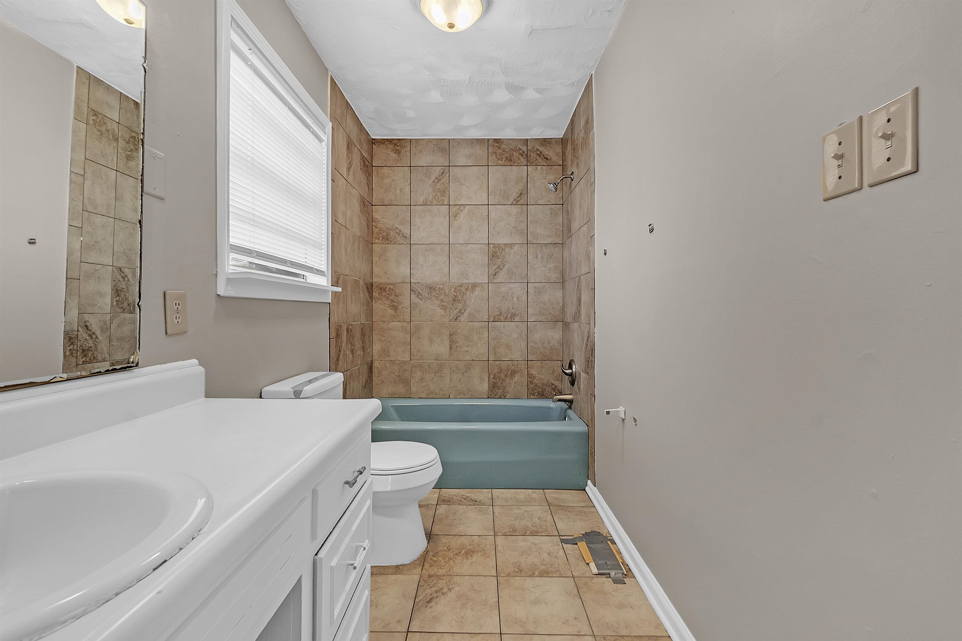 1887 North Graham Street Memphis, TN 38108 - Photo 11 of 13 a bathroom with a sink a toilet and shower