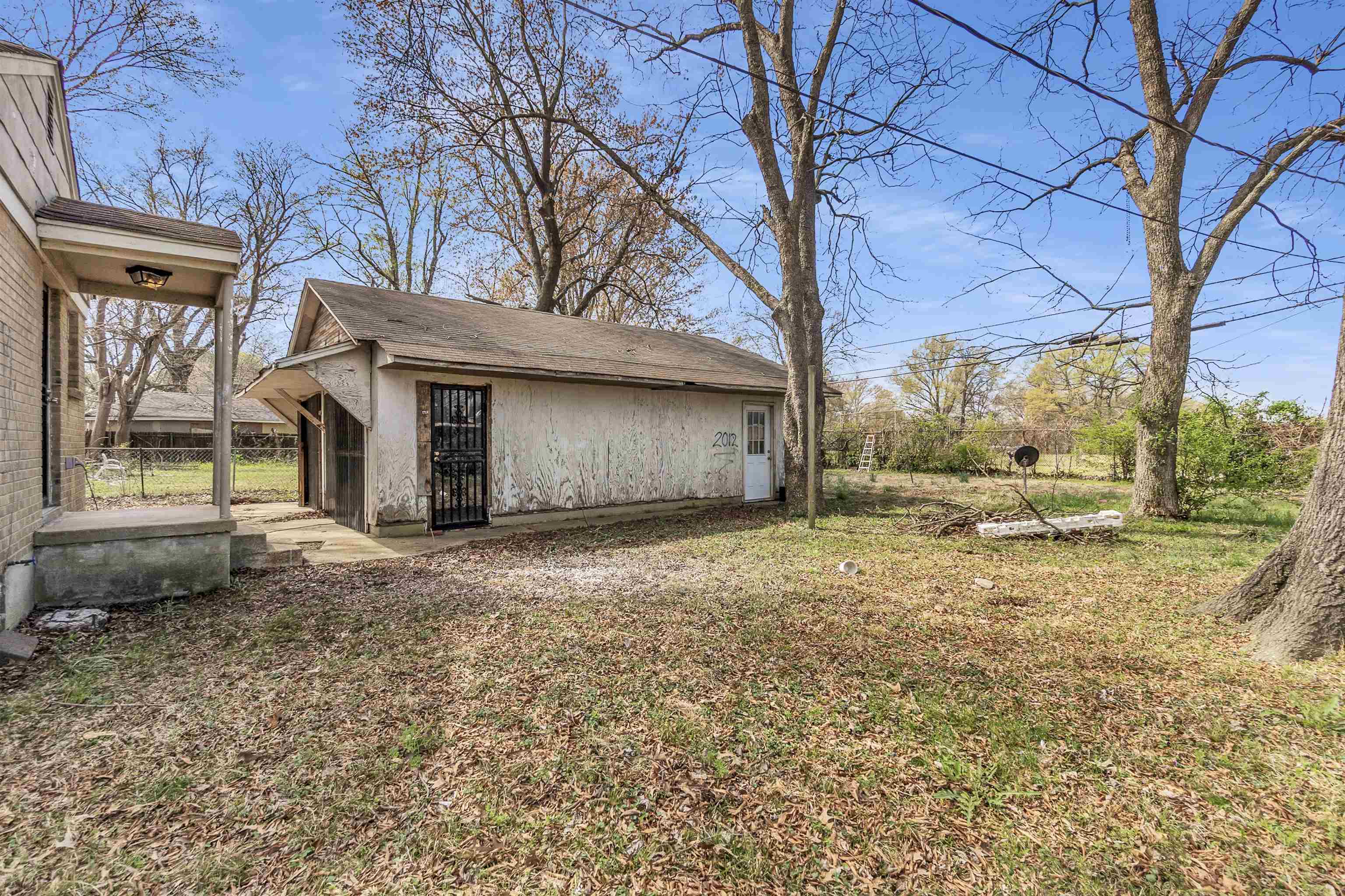 1887 North Graham Street Memphis, TN 38108 - Photo 12 of 13 a view of a house with a yard and garage
