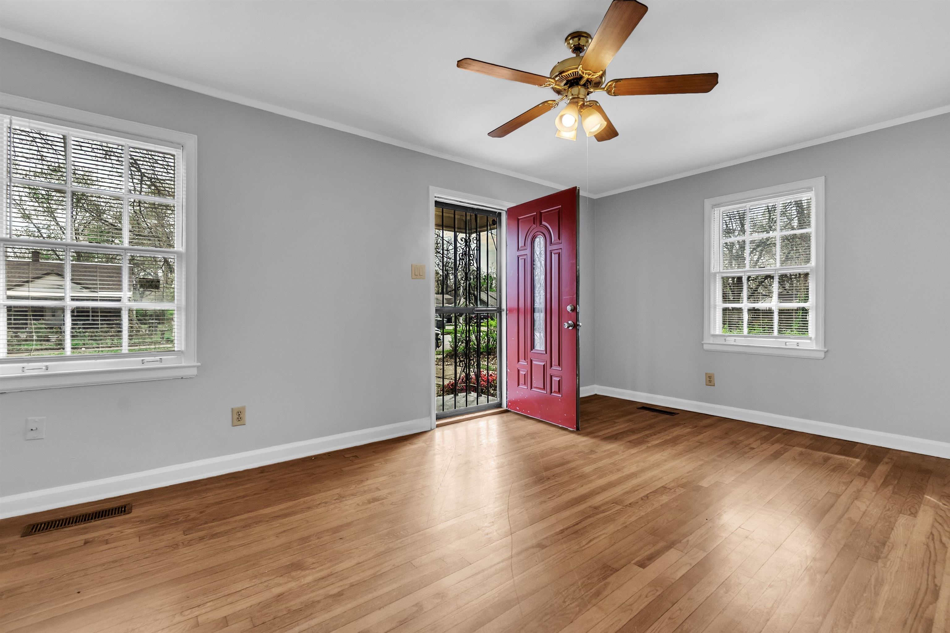 1887 North Graham Street Memphis, TN 38108 - Photo 3 of 13 a view of an empty room with window and wooden floor