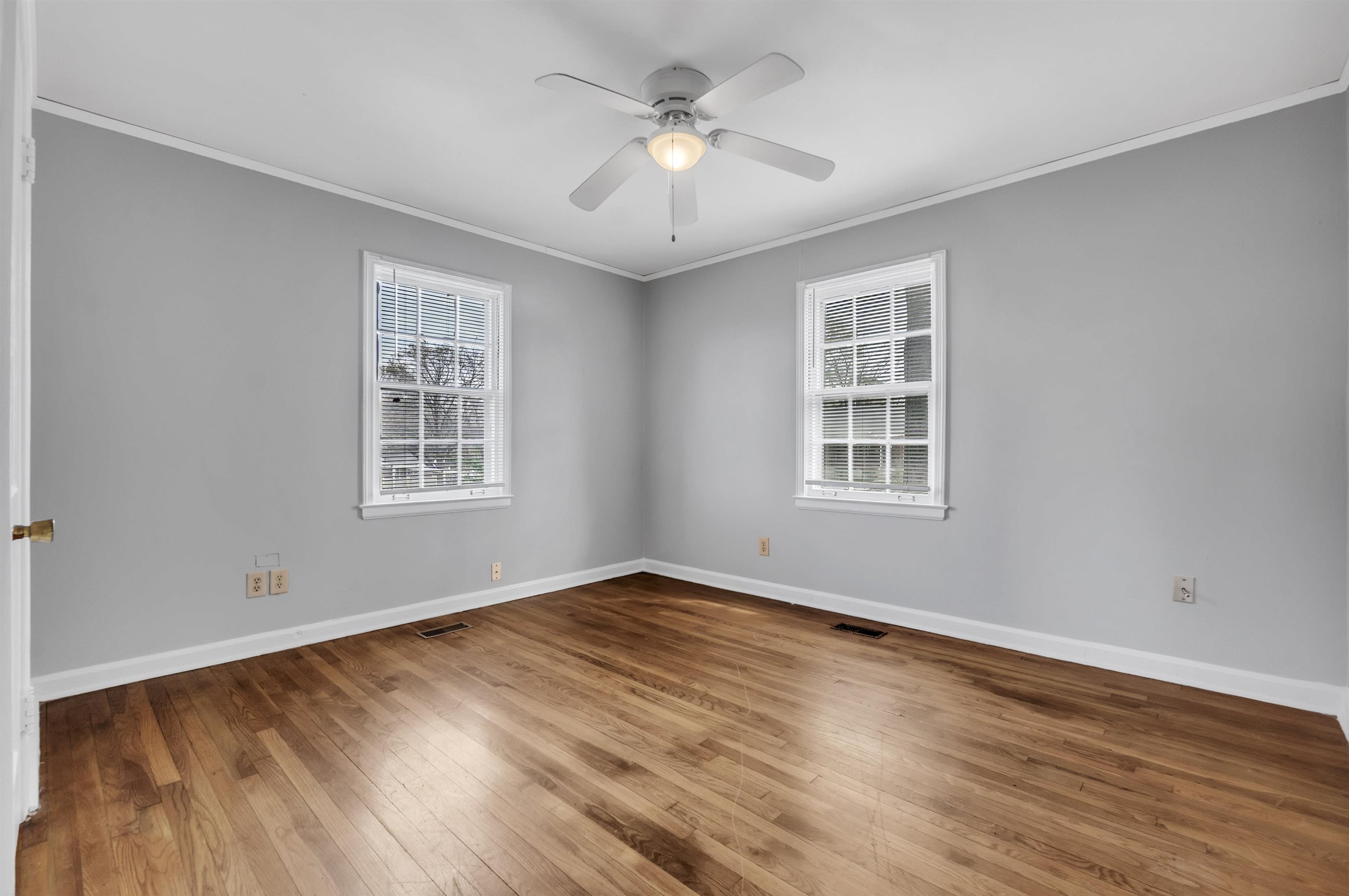 1887 North Graham Street Memphis, TN 38108 - Photo 4 of 13 a view of an empty room with wooden floor and a window