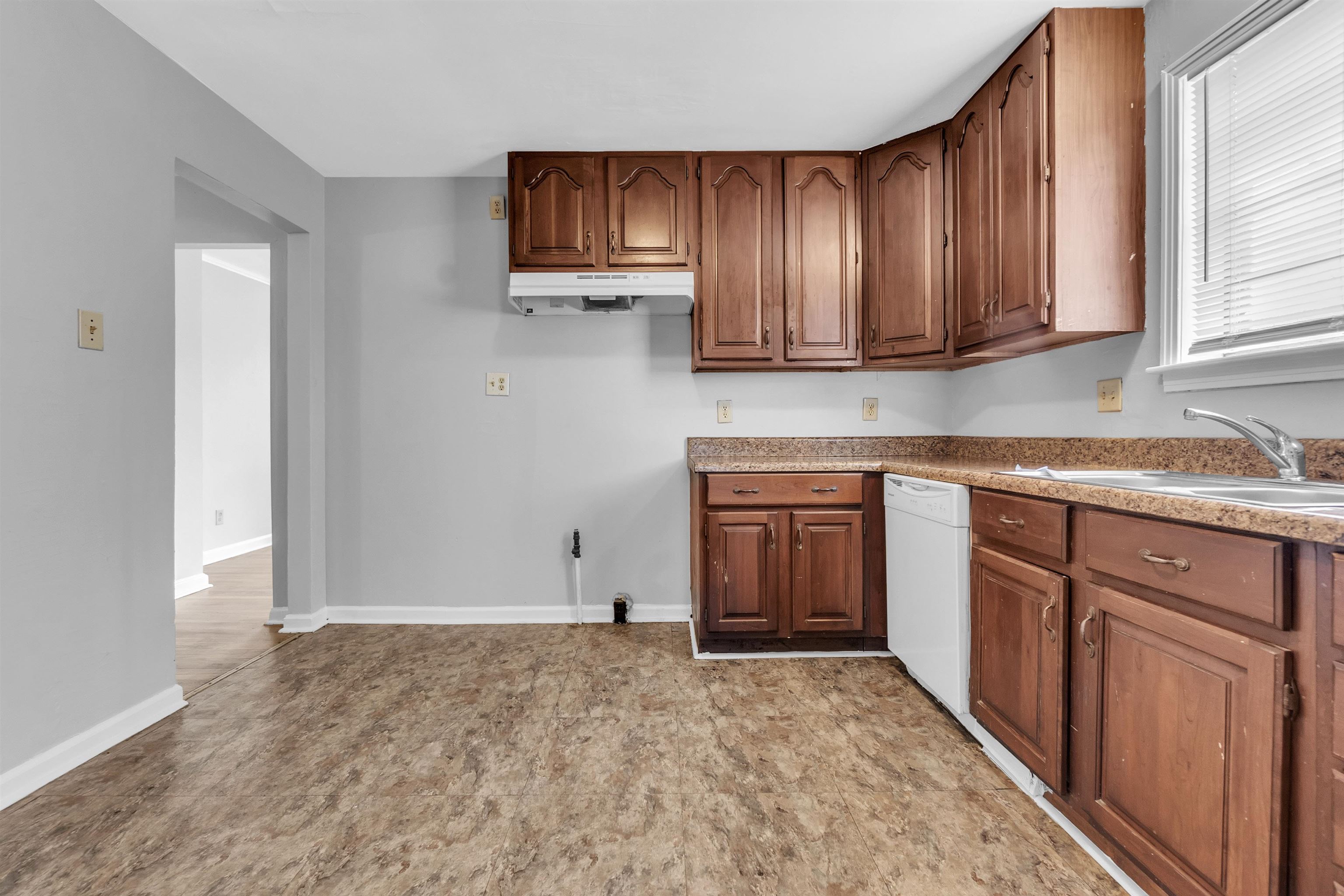 1887 North Graham Street Memphis, TN 38108 - Photo 8 of 13 a kitchen with stainless steel appliances granite countertop a refrigerator and cabinets