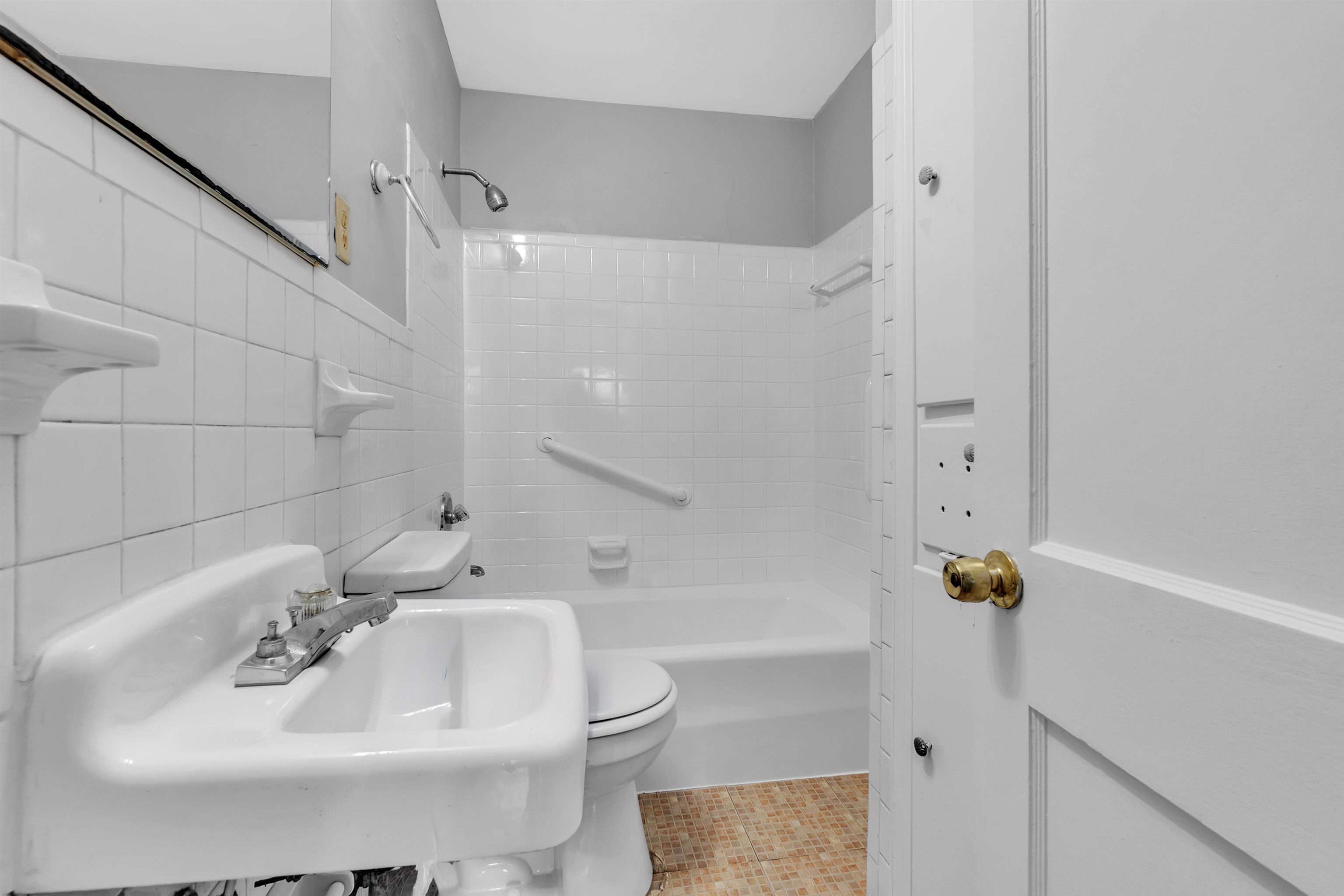 1887 North Graham Street Memphis, TN 38108 - Photo 10 of 13 a bathroom with a sink and a mirror