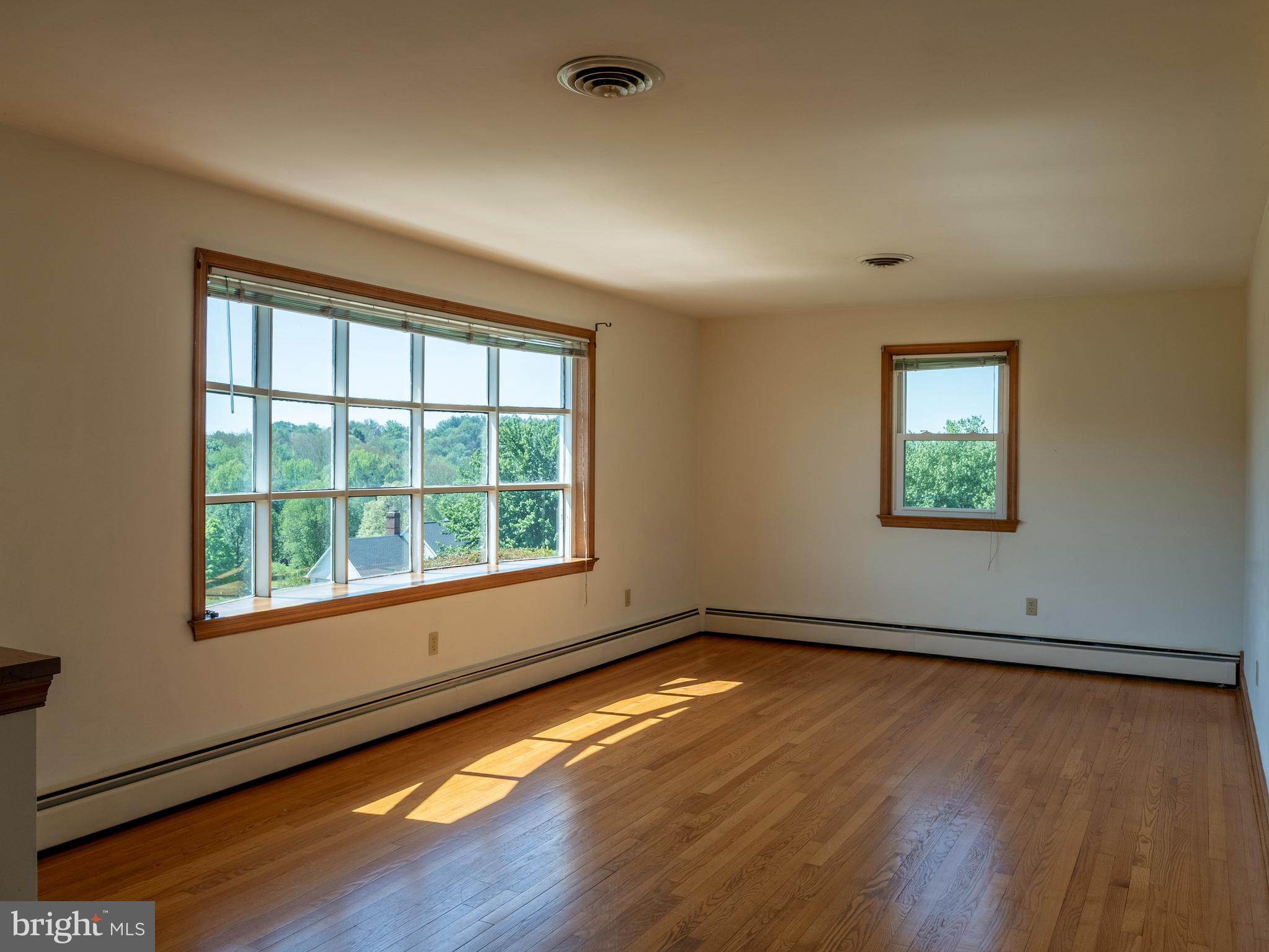 26906 Clarksburg Road Damascus, MD 20872 - Photo 4 of 17 a view of an empty room with wooden floor and a window