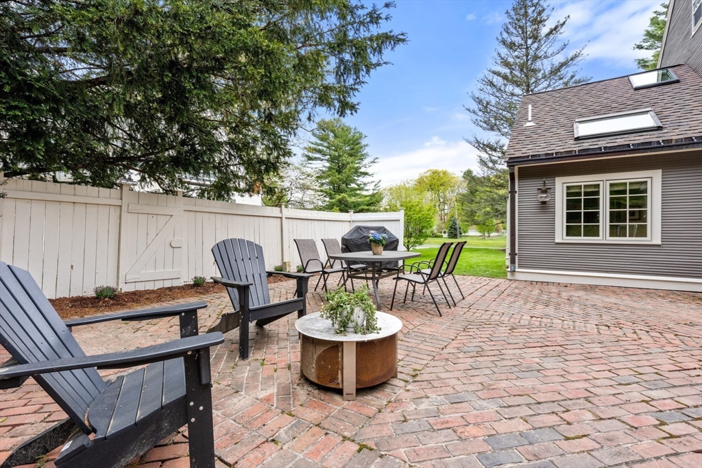 41 Longmeadow Road Wellesley, MA 02482 - Photo 35 of 41 a view of a patio with table and chairs potted plants and a large tree