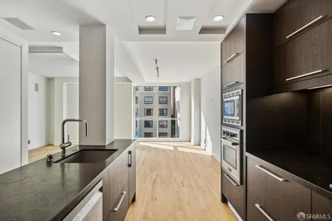 a kitchen with a sink stove and cabinets